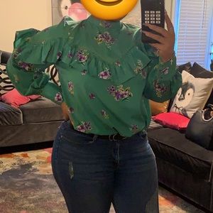 Very pretty blouse with flower pattern and ruffles throughout.